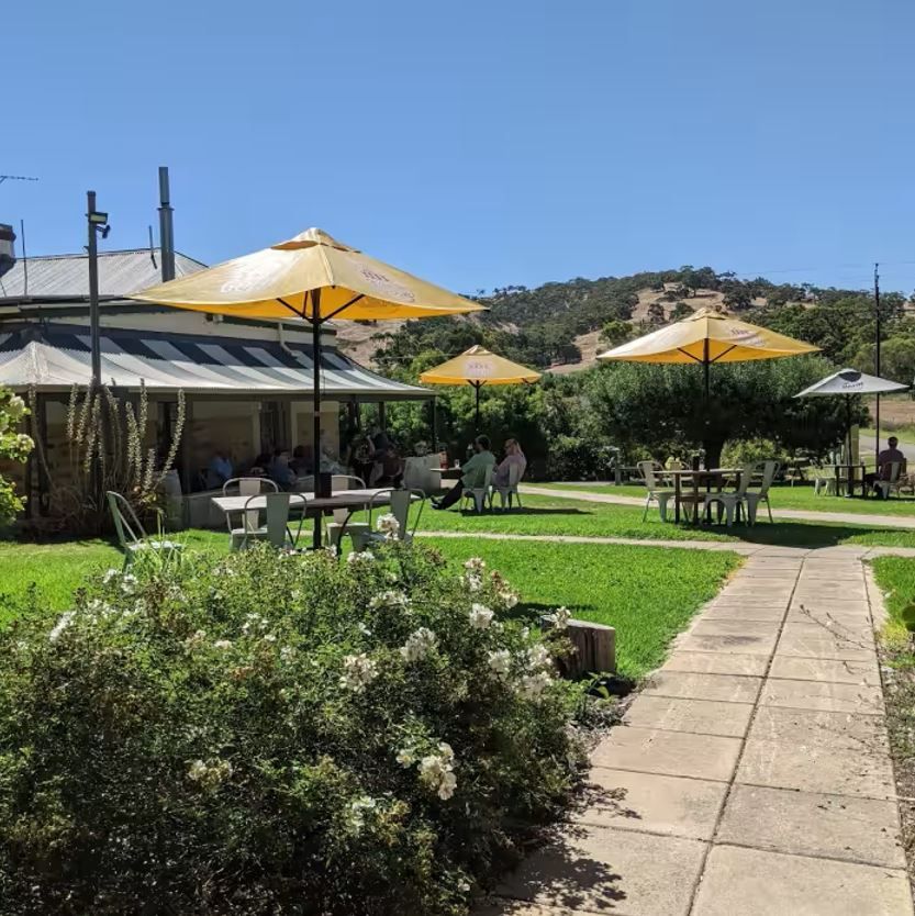 The Greenman Inn garden with umbrellas, guests and the hills beyond
