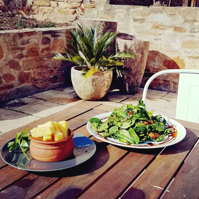 Fresh garden salad on the timber tables outside